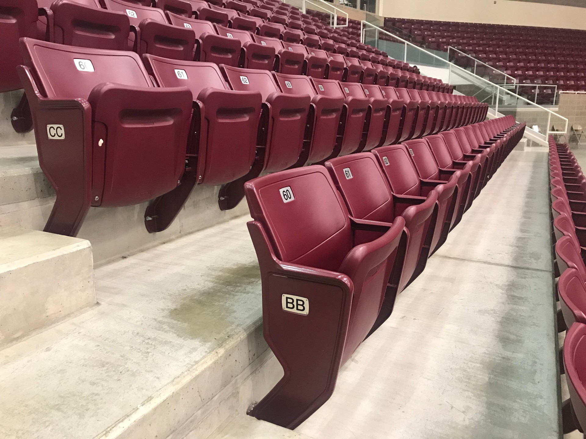 Rows of maroon seats in a basketball arena